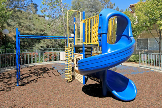 Children's playground with monkey bars and climbing equipment and slide